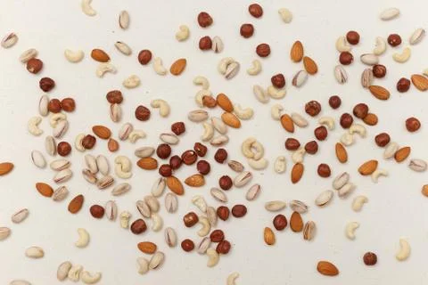 Composition of nuts pattern - mix hazelnuts, cashews, almonds, pistachios. Stock Photos