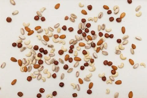 Composition of nuts pattern - mix hazelnuts, cashews, almonds, pistachios. Stock Photos
