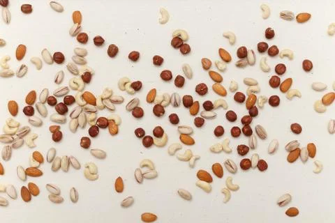 Composition of nuts pattern - mix hazelnuts, cashews, almonds, pistachios. Stock Photos