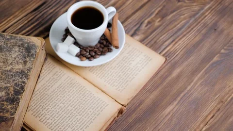 Composition of the old books and cup of coffee on a wooden table. Stock Footage 131004067