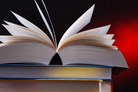 Composition with open book on the table. Stock Photos