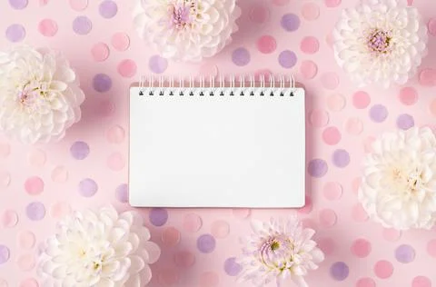 Composition of opened notepad framed with white flowers and colorful round Stock Photos