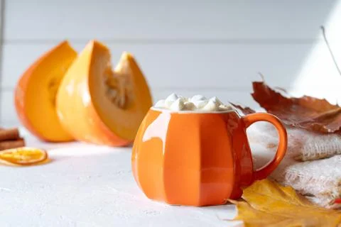 Composition with orange pumpkin styled cup of coffee with marshmallows and au Stock Photos