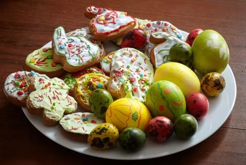 Composition of painted Easter eggs and cookies on a plate Stock Photos