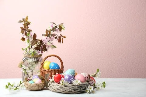Composition with painted Easter eggs and blossoming branches on table. Space  Stock Photos