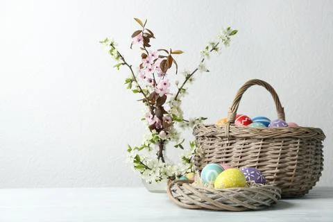 Composition with painted Easter eggs and blossoming branches on table. Space  Stock Photos