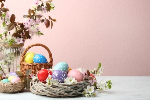 Composition with painted Easter eggs and blossoming branches on table. Space  Stock Photos