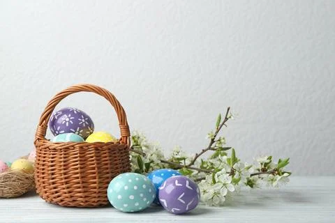 Composition with painted Easter eggs and blossoming branches on table. Space  Stock Photos