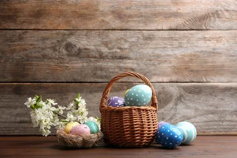 Composition with painted Easter eggs and blossoming branches on table. Space  Stock Photos