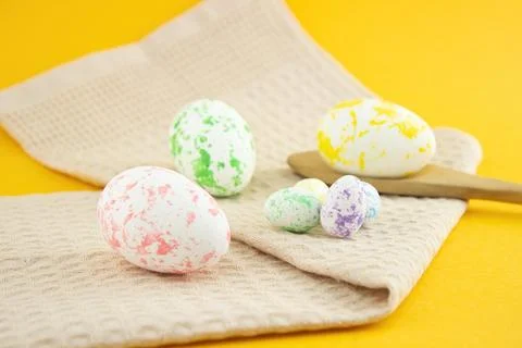 Composition of painted eggs, chicken and quail with a wooden spoon and a beig Stock Photos