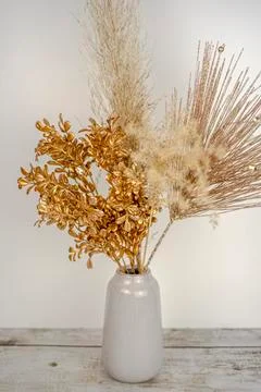 Composition of pampas grass with New year golden branch decoration in a vase on Stock Photos