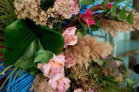 Composition of pampas grass, palm trees and roses. Decorative floral design.The Stock Photos