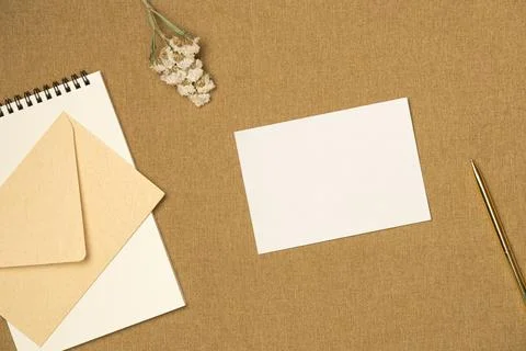 Composition with paper blank sheet on fabric background from above. Space f.. Stock Photos