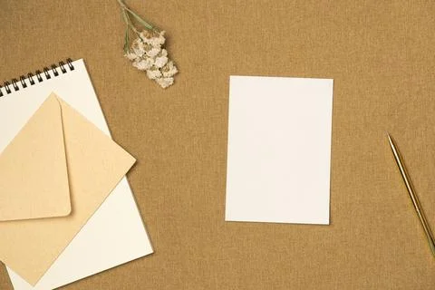 Composition with paper blank sheet on fabric background from above. Space f.. Stock Photos