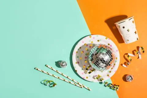 Composition with paper cup, plate and disco balls on color background Stock Photos