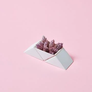 Composition of paper triangular boxes with cones on a pink background with .. Stock Photos