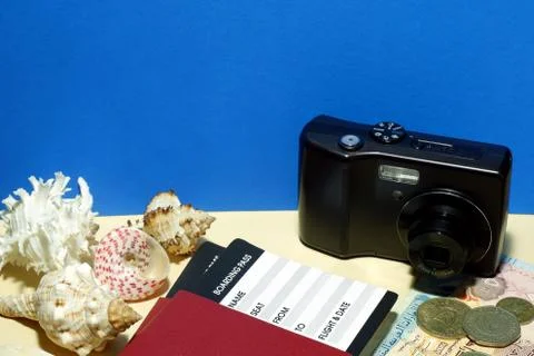 Composition from passport with boarding pass, compact camera, sea shells 스톡 사진
