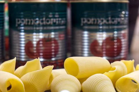 Composition with pasta and jars of peeled tomatoes Stock Photos
