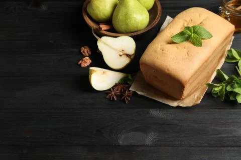 Composition with pear bread on black wooden table, space for text. Homemade c Stock Photos