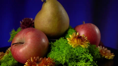 Composition of pears, apples, moss and yellow flowers. Stock Footage 149112840