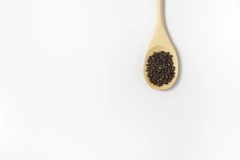 Composition of peppercorns on a spoon in flat lay. Stock Photos