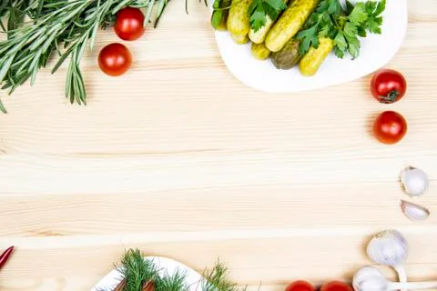 Composition with pickled cucumbers on the white plate,  tomatoes, garlic, dil Stock Photos