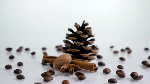 Composition of pine cone and beans of coffee rotating on a white background. Stock Footage 131005082