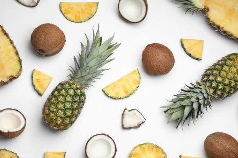 Composition with pineapple and coconut on white background, top view Stock Photos