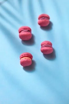 Composition of pink colored macaroon on blue background, flat lay Стоковые фото