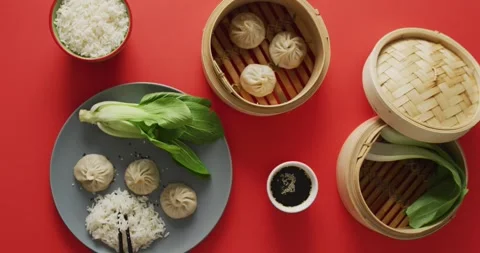 Composition of plate and bamboo steamers with dim sum dumplings, pak choi and Stock Footage 331245768
