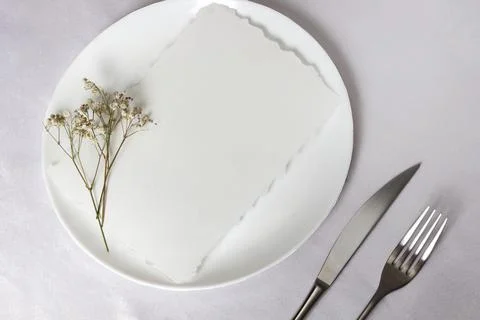 Composition, a plate with flowers, a fork and a knife on a white tablecloth Stock Illustration