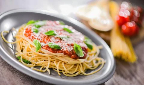 Composition with a plate of spaghetti bolognese. Stock Photos