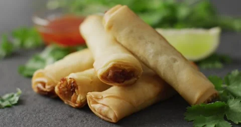 Composition of plate with spring rolls and chilli sauce on black background Stock Footage 331447456