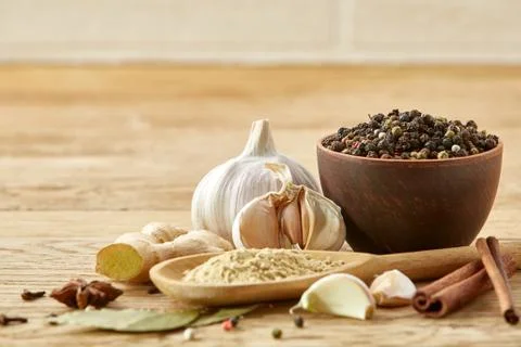 Composition of powder spices on spoon and different sorts of spicies on wooden Stock Photos