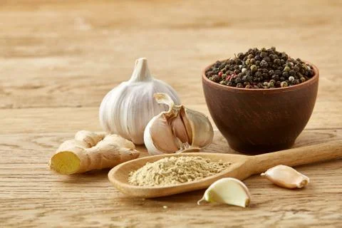 Composition of powder spices on spoon and different sorts of spicies on wooden Stock Photos