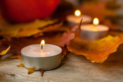 Composition with pumpkins and candles on maple leaves on wooden background. S Foto stock