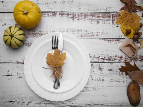 Composition with pumpkins and cutlery on an old table Stock Photos