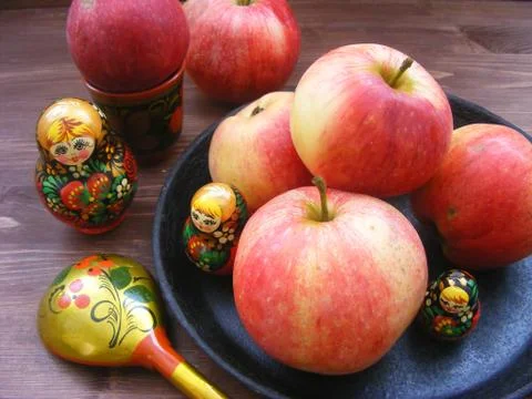 Composition of red and yellow apples on cast iron plate with traditional russ Stock Photos