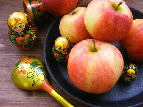 Composition of red and yellow apples on black cast iron plate with traditiona Stock Photos
