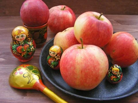Composition of red and yellow apples on cast iron plate with traditional russ Stock Photos
