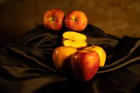 Composition of red apples and black satin Stock Photos
