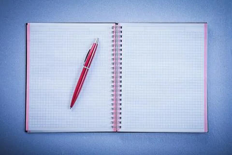 Composition of red ball-point pen open copybook office concept Stock Photos