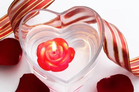 Composition with red candle and red ribbon Stock Photos
