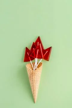 Composition of red lollipops in the shape of a triangle in a waffle Cup on a  Stock Photos