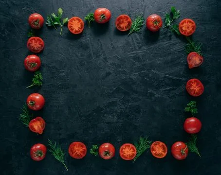Composition of red tomatoes and green fresh parsley and dill lying on dark .. 写真素材