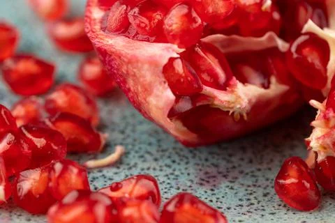 Composition with ripe pomegranates on blue table Stock Photos