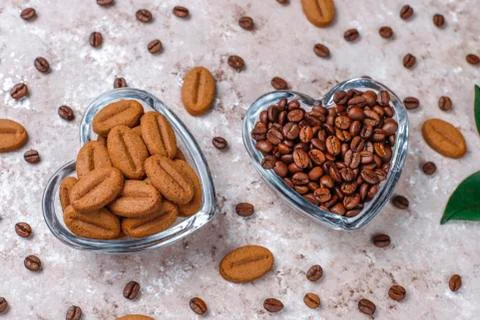 Composition with roasted coffee beans and coffe bean shaped cookies Stock Photos