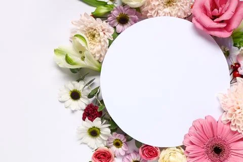 Composition with round blank card and beautiful flowers on white background,  Foto stock