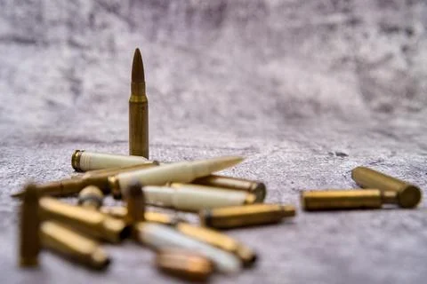 Composition of rounds of ammunition on floor Stock Photos