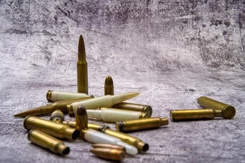Composition of rounds of ammunition on floor Stock Photos